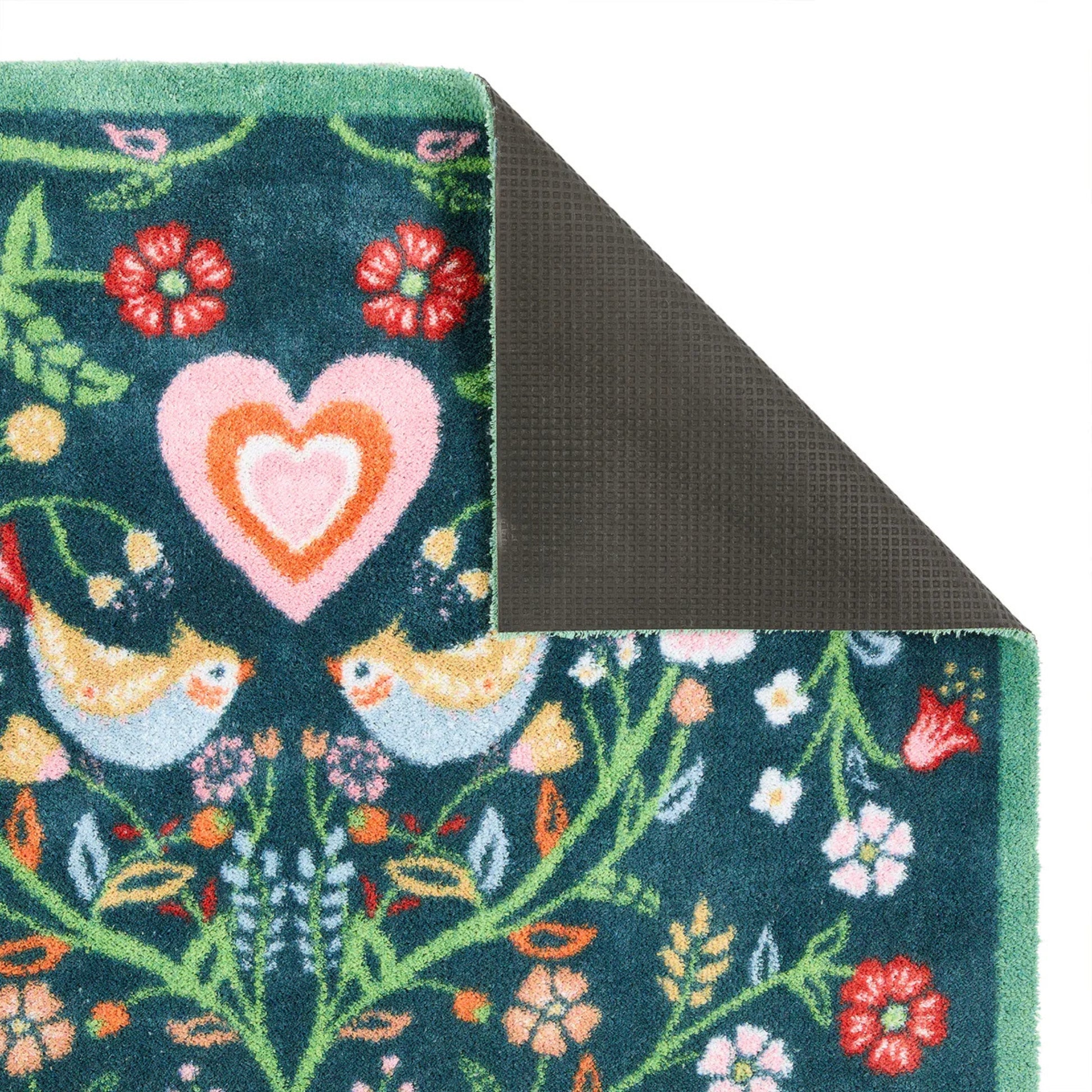 Floral and heart design rug corner with green border