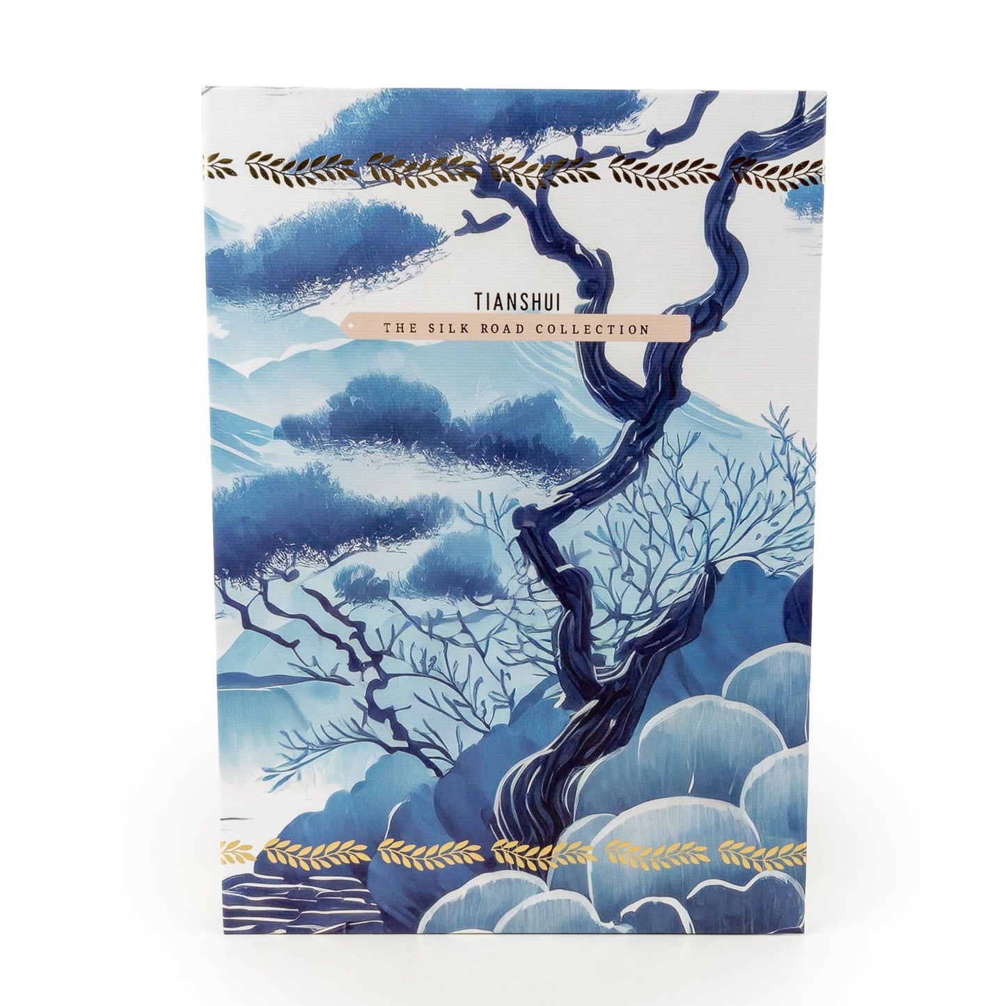 Notebook with blue tree design and gold accents on a white background