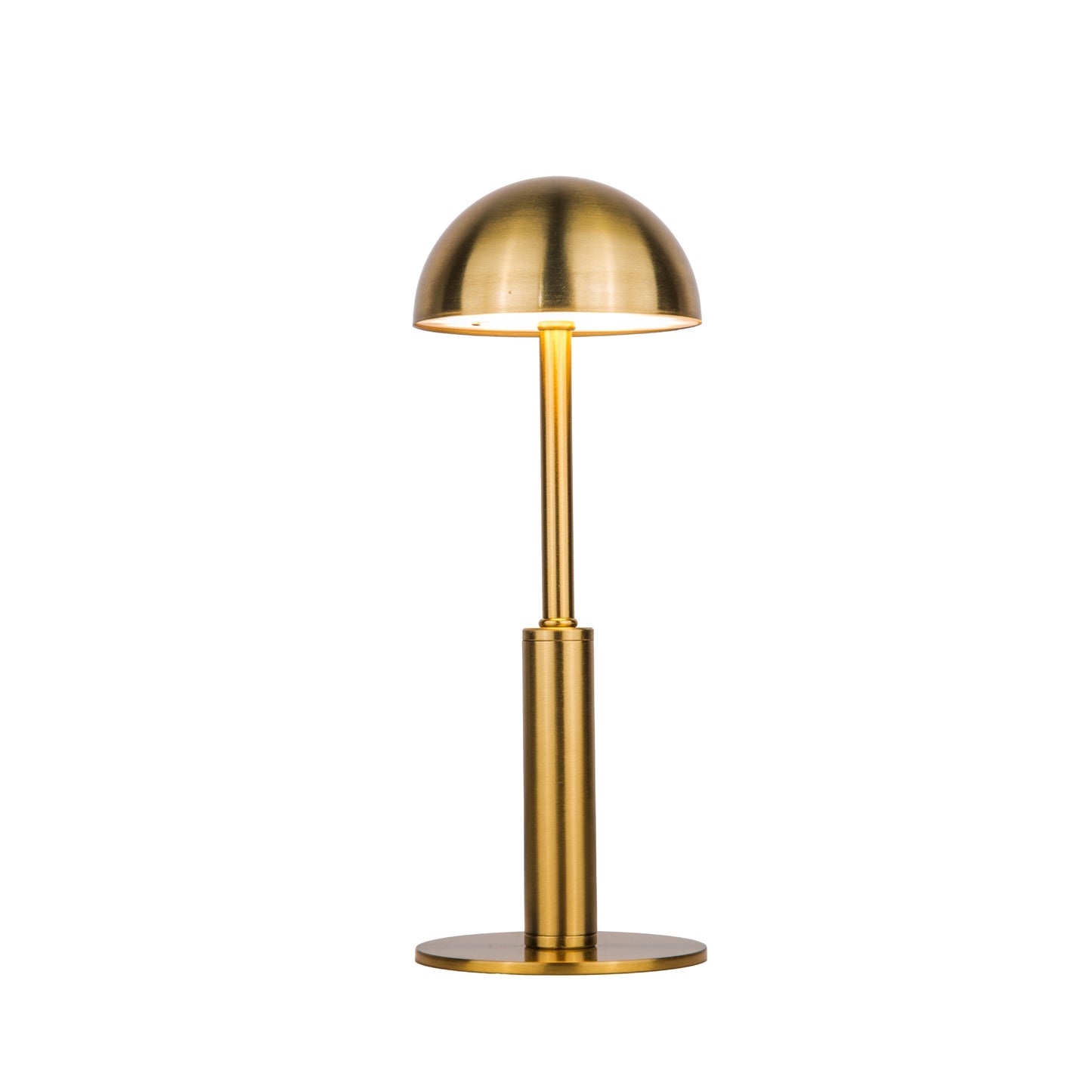 Lit Gold dome shaped metal table lamp on a white background