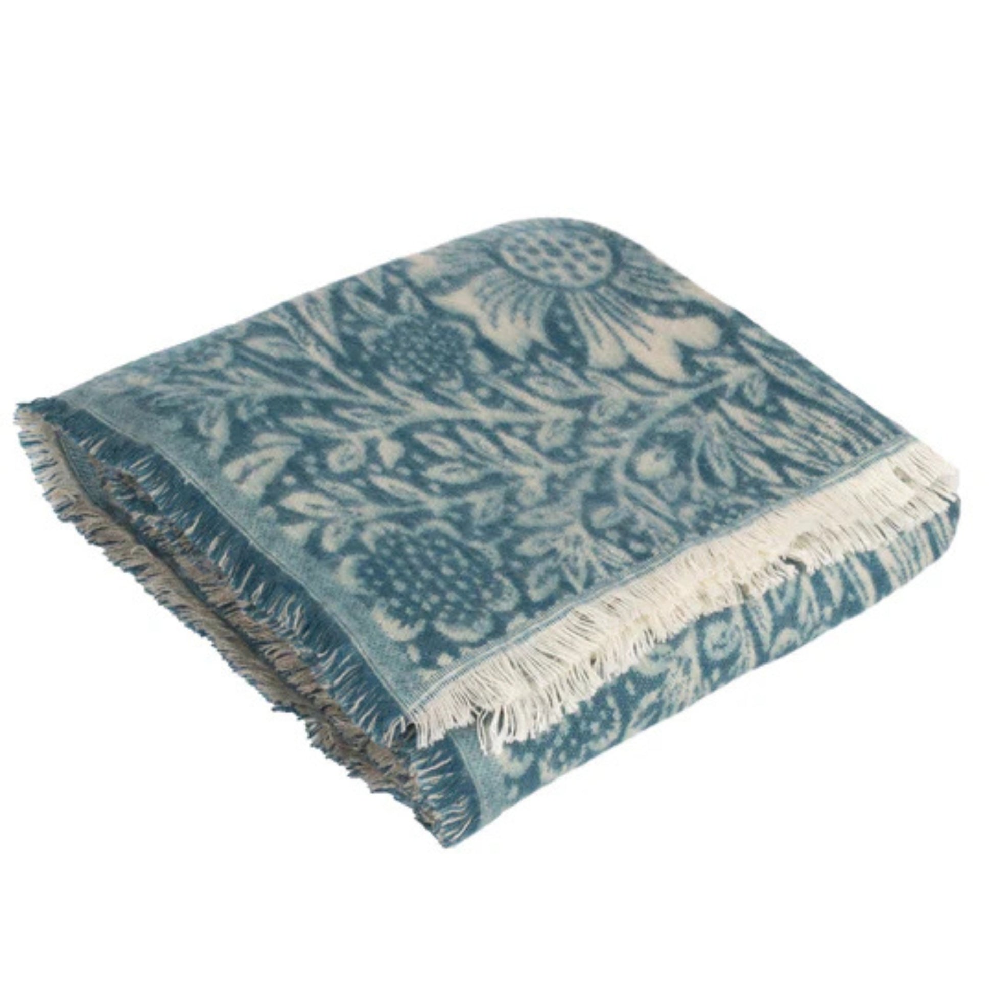 Blue and white patterned throw blanket with fringes on a white background