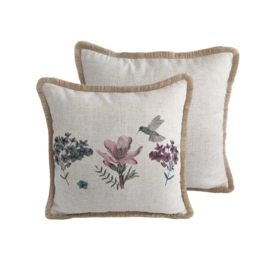 Two decorative pillows with floral and bird patterns on a white background