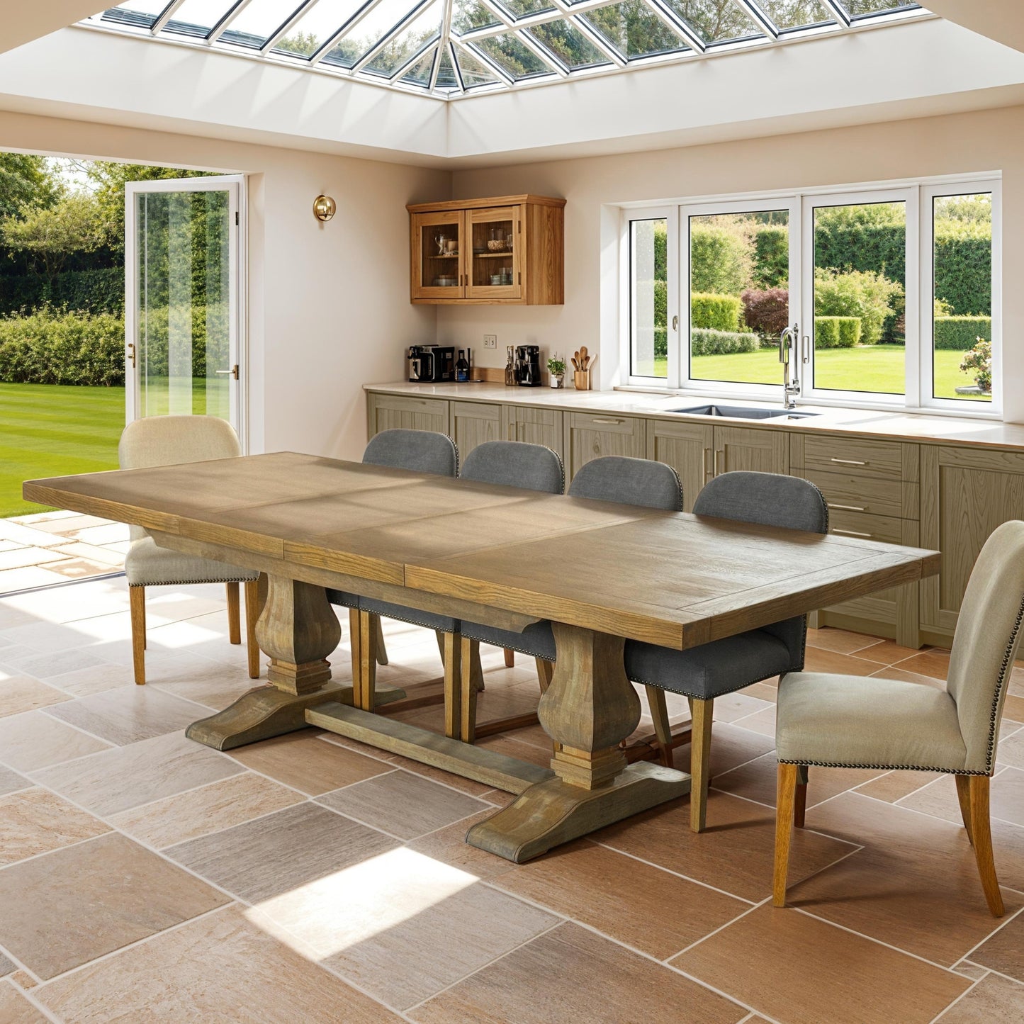 Dining room with a large wooden table and chairs in a well-lit kitchen.
