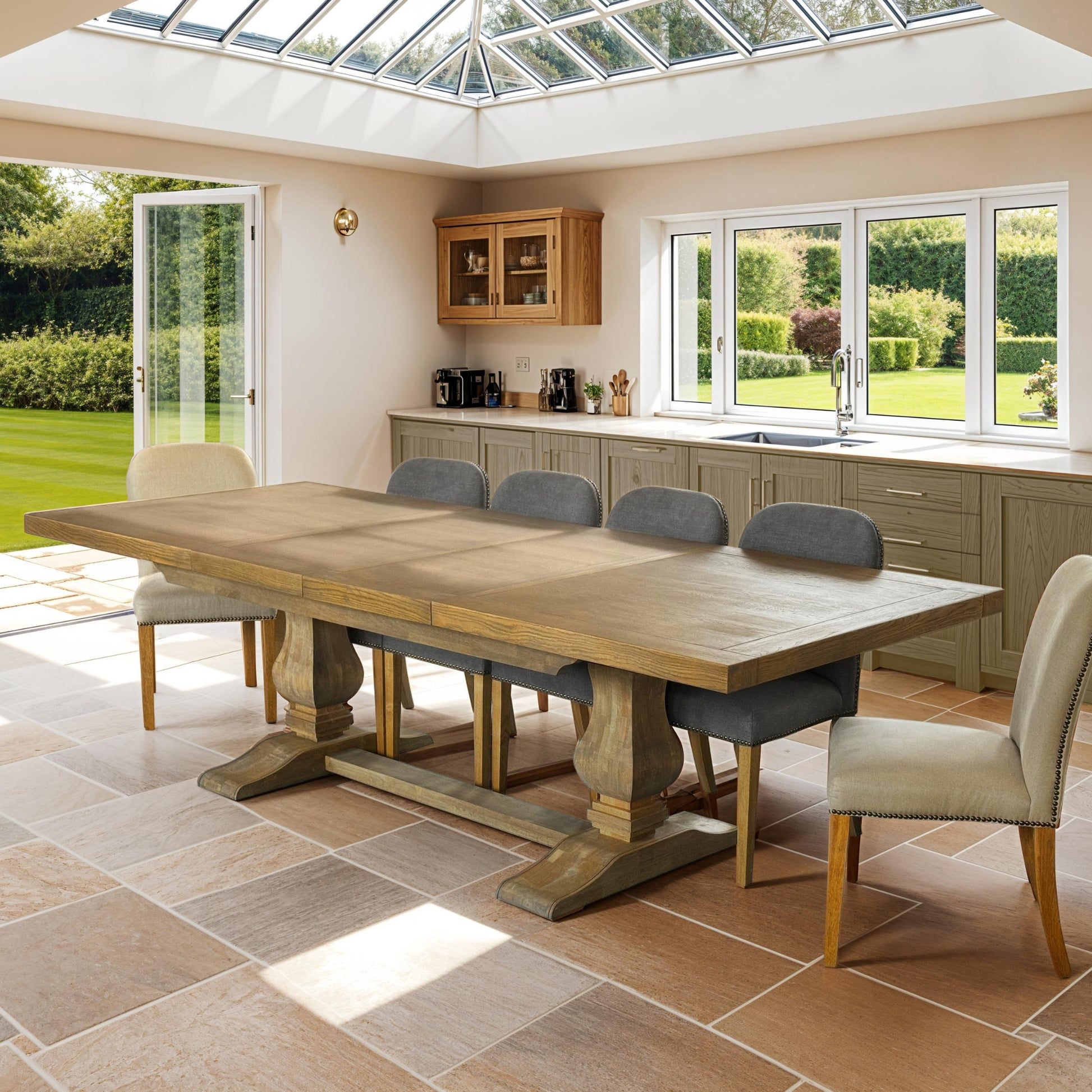 Dining room with a large wooden table and chairs in a well-lit kitchen.