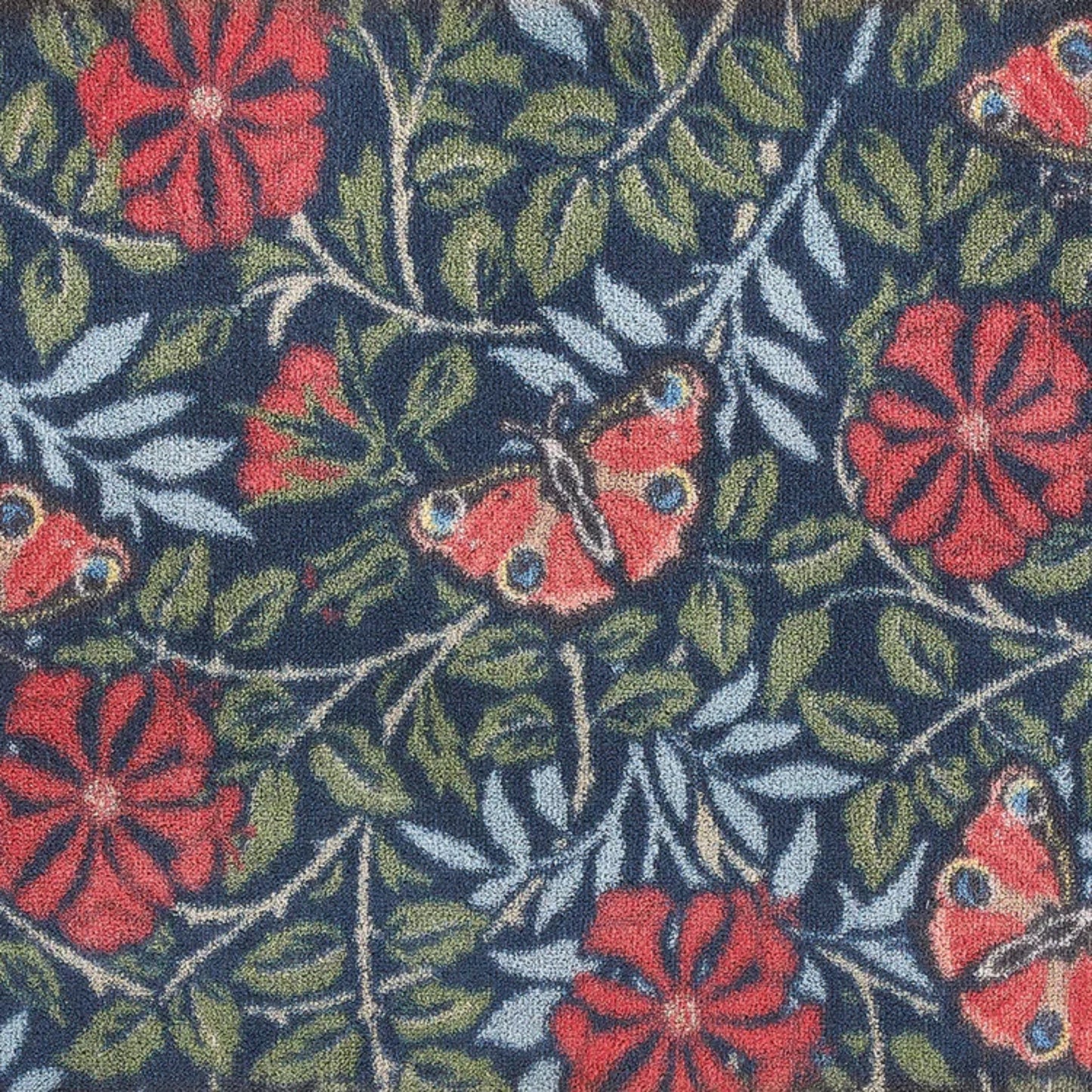 Patterned fabric with red flowers and butterflies on a dark background
