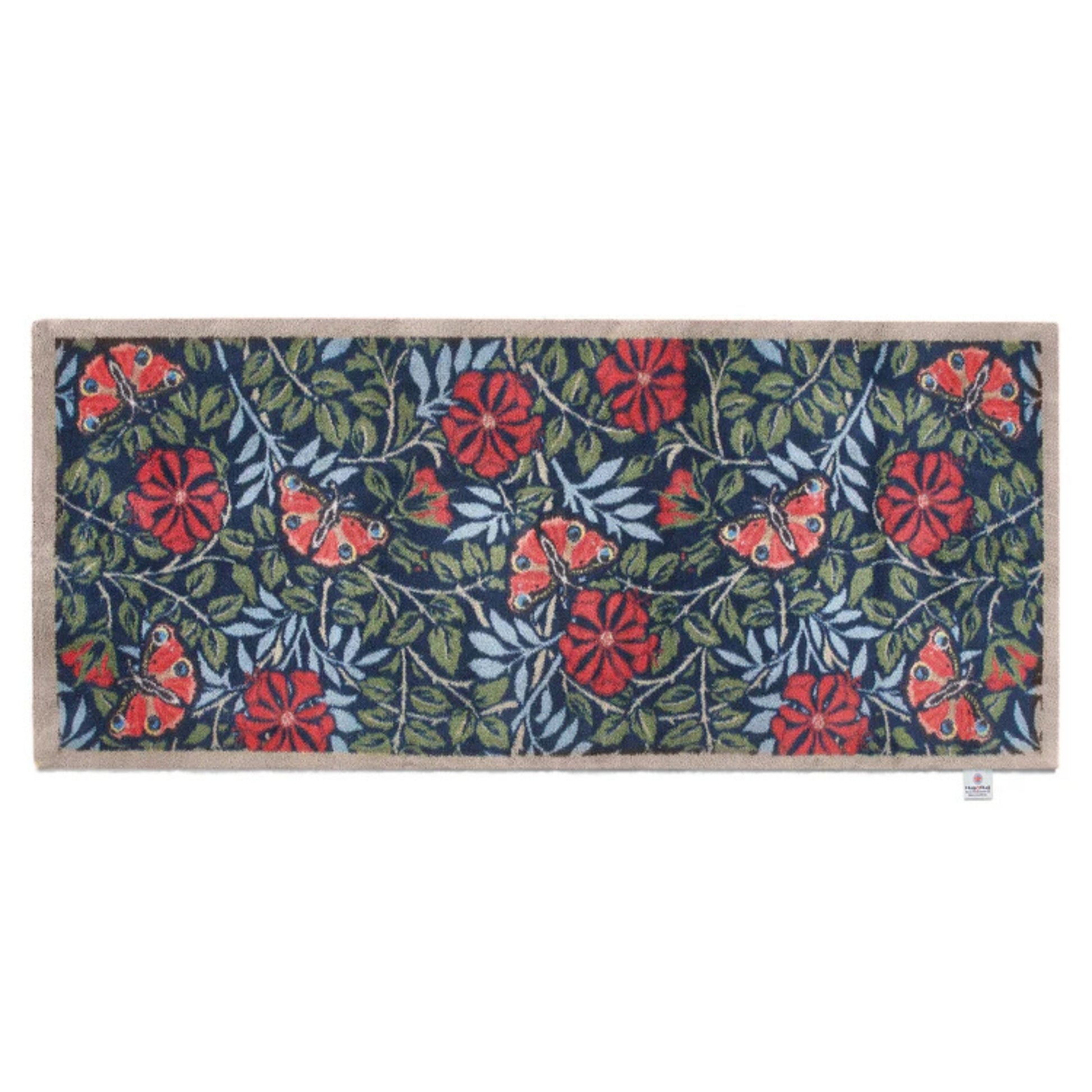 Floral patterned doormat with red flowers and green leaves on a blue background
