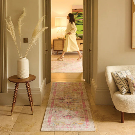 Living room with a rug, side table, and chair.