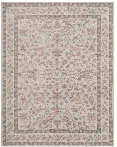 An area rug with a traditional floral and bird pattern in muted pink, gray, and beige tones on a cream background.