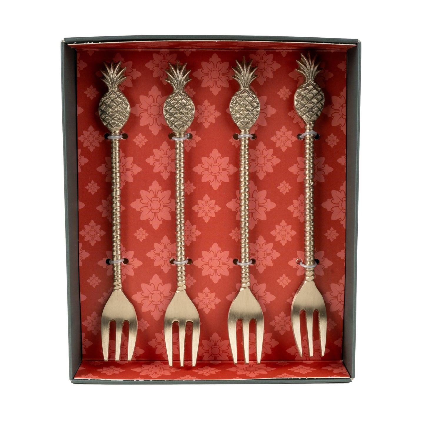 Set of four decorative forks with pineapple designs in a red box with floral patterns.