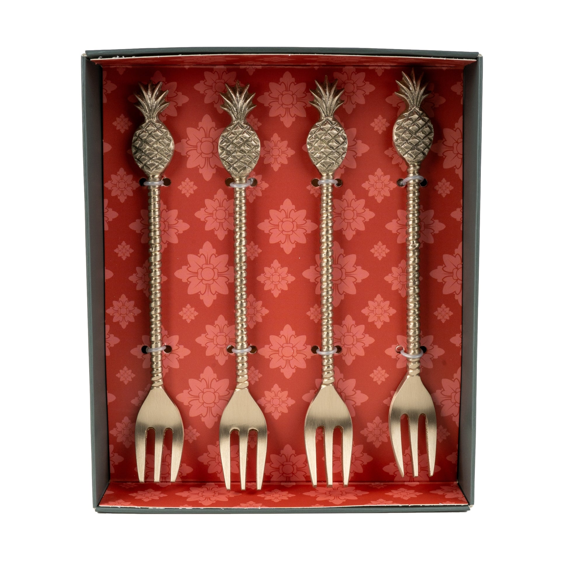 Set of four decorative forks with pineapple designs in a red box with floral patterns.