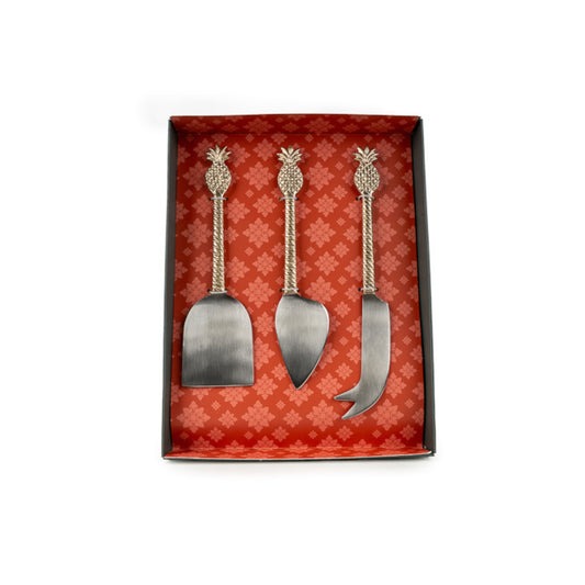 Set of three metal cheese tools with pineapple handles in a decorative box.