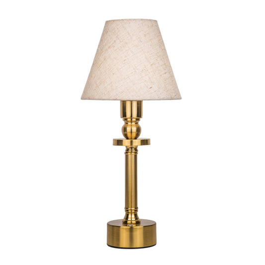 Table lamp with gold base and beige lampshade on a white background