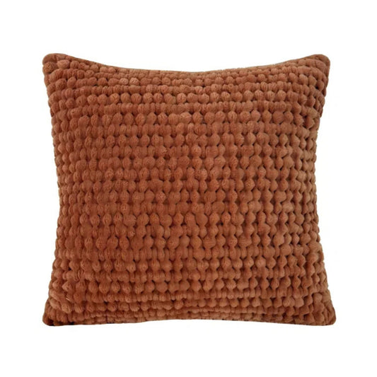 Rust textured pillow on a white background