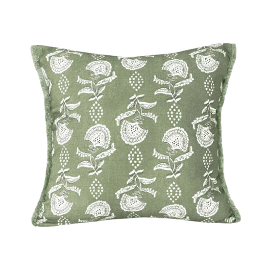 Green pillow with white floral pattern on a white background