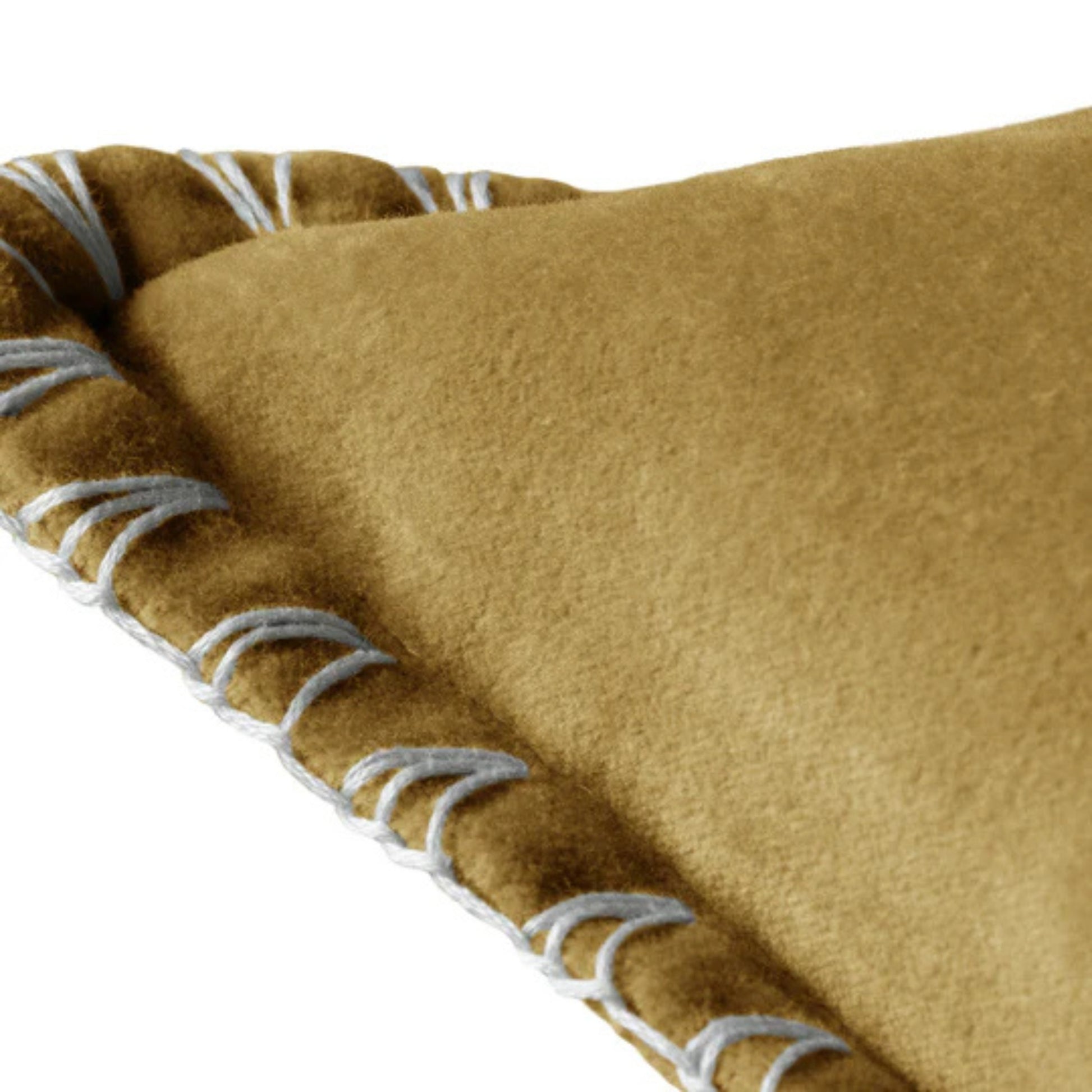 Mustard cushion corner with with white stitching detail on a white background