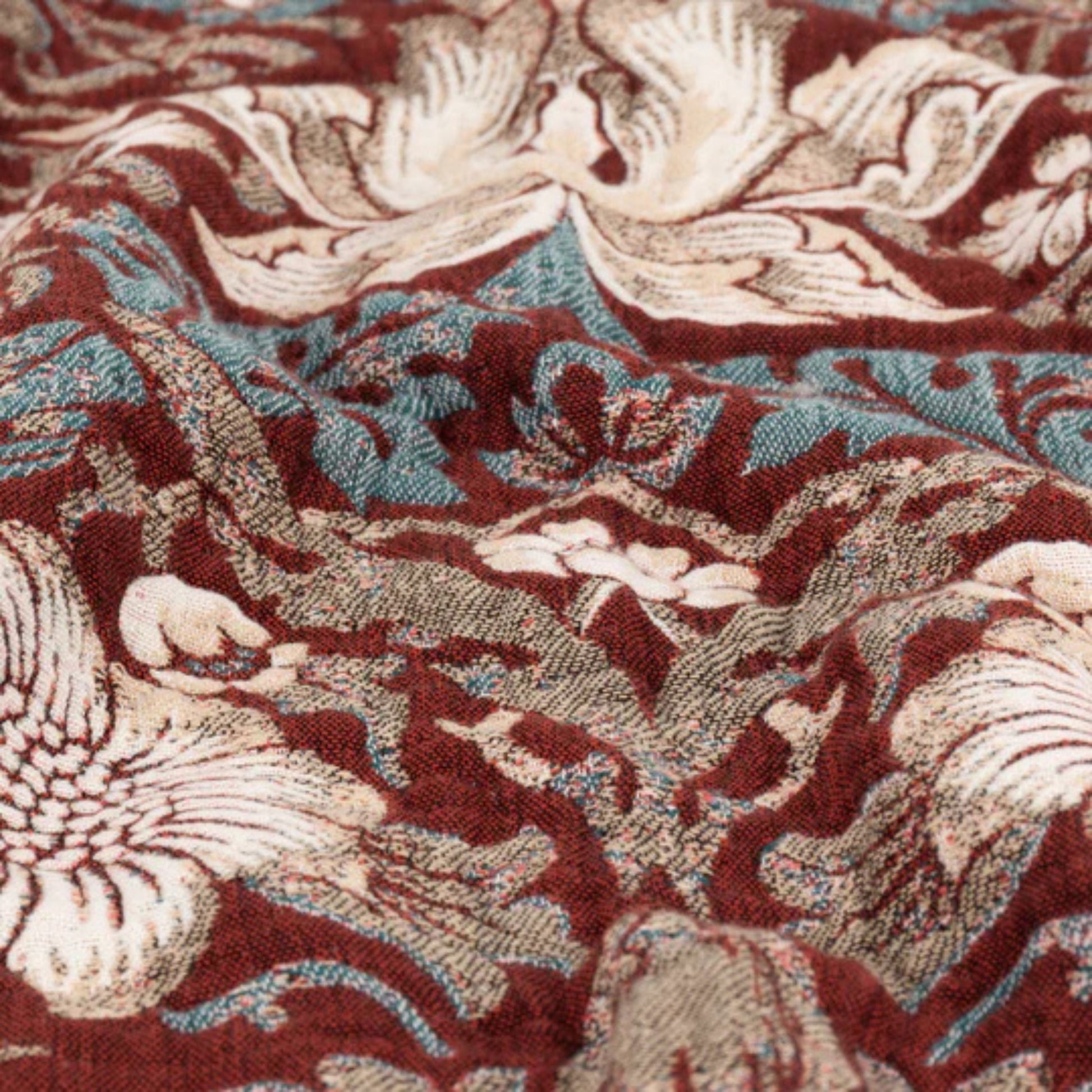 Close-up of a patterned fabric with swan design on a red background
