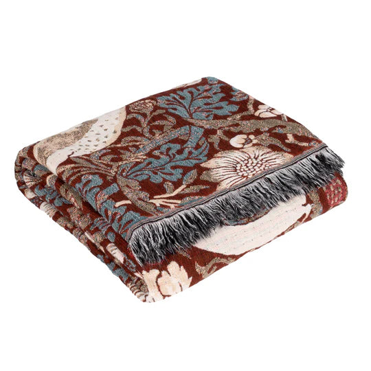 Floral patterned throw blanket with fringes on a white background