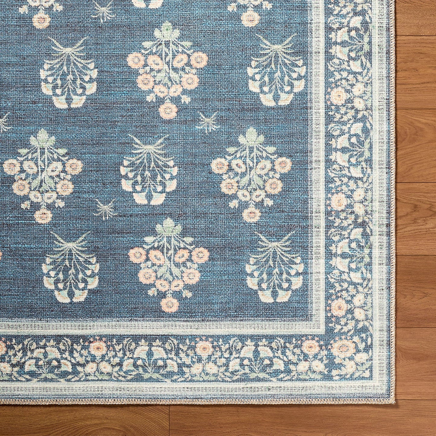Decorative rug with floral pattern on a wooden floor