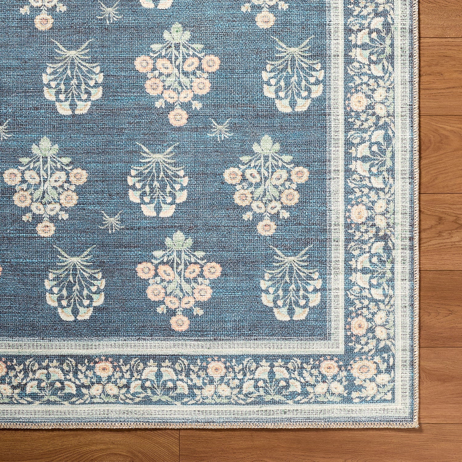 Decorative rug with floral pattern on a wooden floor