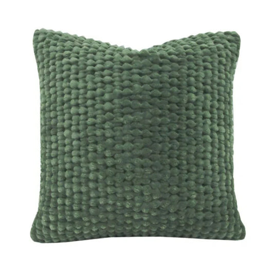 Textured green pillow on a white background