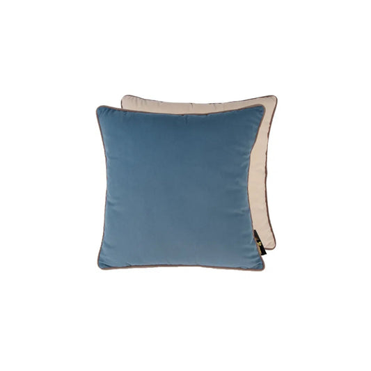 A large square cushion with one half in blue velvet and the other half in champagne velvet, both with taupe piping.