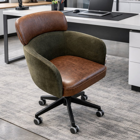 Leather and fabric curved office chair on castors in an office setting next to a desk