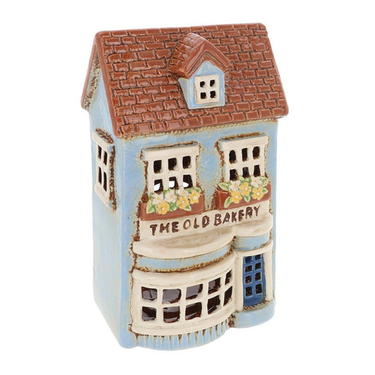 Decorative miniature model of a bakery building with 'The Old Bakery' sign on a white background.