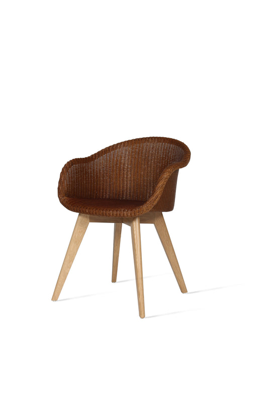 A dining chair with a caramel Lloyd Loom weave seat and an oak wood 