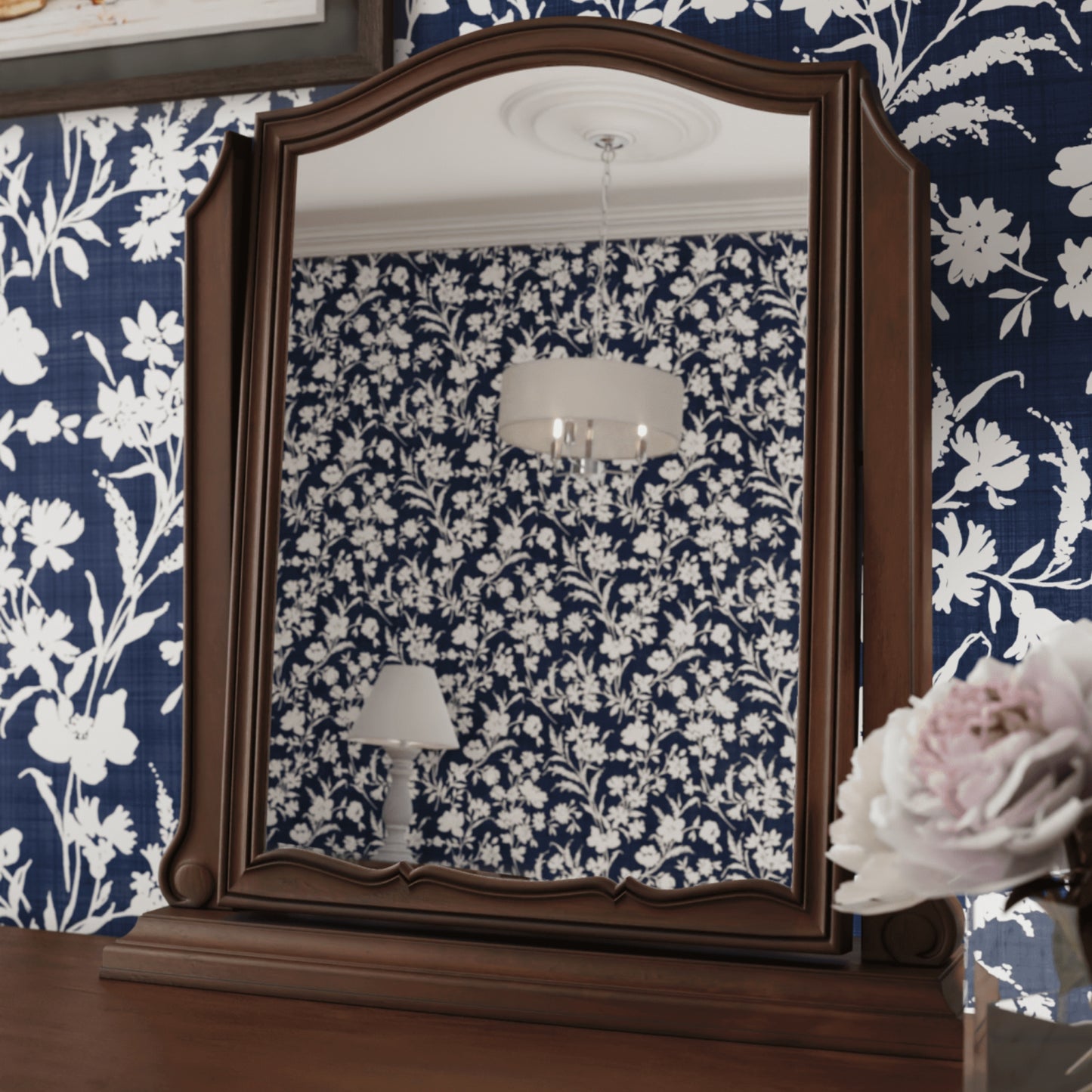 Walnut Vanity mirror on a walnut table with a navy and white floral background 