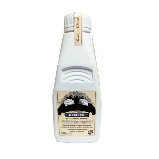 A bottle of Celtic Wood Care Furniture Polish with a white label and a black and gold design detail.